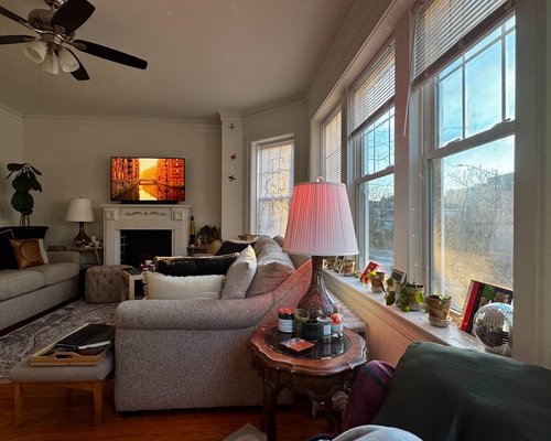 Living room with large windows letting in soft natural light on an overcast day