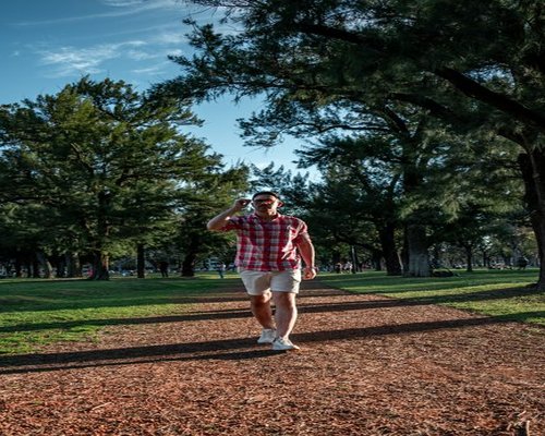 Person taking a walk in a green urban park like Parque Forestal
