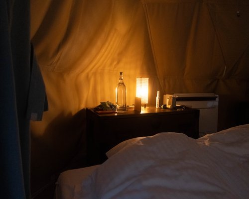 Glass of water on a bedside table with a warm reading lamp